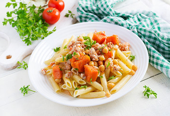 Italian pasta, penne with minced meat, chickpeas and pumpkin. Healthy food. Pasta with forcemeat.