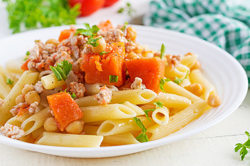 Italian pasta, penne with minced meat, chickpeas and pumpkin. Healthy food. Pasta with forcemeat.
