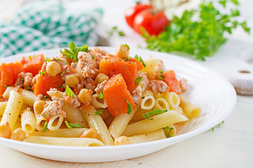 Italian pasta, penne with minced meat, chickpeas and pumpkin. Healthy food. Pasta with forcemeat.