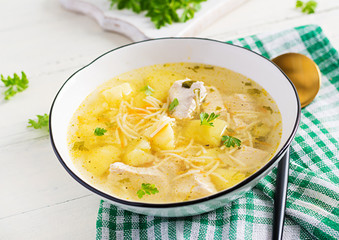 Diet soup. Chicken soup with noodles and vegetables in white bowl.