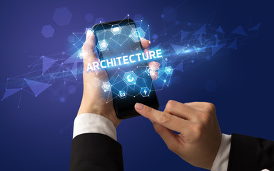 Female hand holding smartphone with ARCHITECTURE inscription, modern technology concept