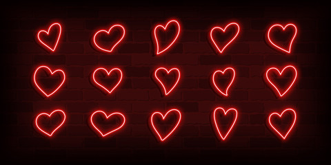 Set of 15 different simple red neon hearts on a brick wall for Valentines day card design. Vector illustration.