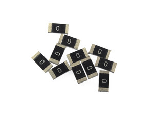 SMD resistors isolated on white background. On the body inscription value 0 Ohm