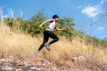 Young Black Woman Running and  Jumping at Forest Trail.