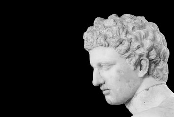 Black and white photo showing detail of male head of classical roman statue