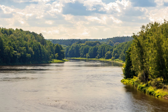 Druskininkai, Lithuania: Tourists are floating on the river in a single-engine pleasure craft. Neman, Nemunas, Nyoman, Niemen or Memel, a major Eastern European river. The view on Nemunas