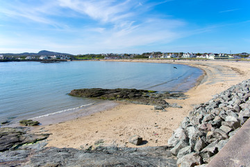 Fototapeta na wymiar Beach at Trearddur bay on the Welsh island of Anglesey. A spring day and the is quiet. Curved bay with pristine sands.