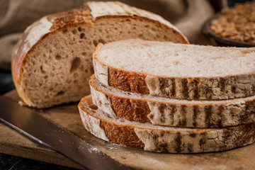 Freshly baked bread cut into chunks on a wooden Board
