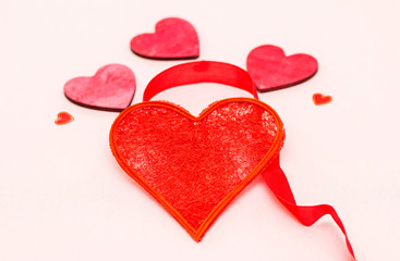 beautiful red heart decorated with ribbon on a light background