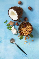 Coconut granola and coconut on a blue stone countertop. Top view flat lay background.