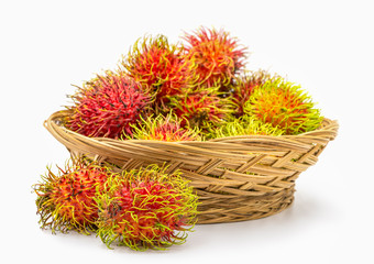 Close up fresh rambutan sweet and delicious fruit in basket isolated on white background.