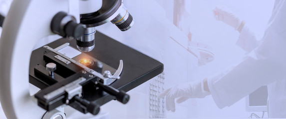 Close-up shot of microscope with the metal lens with blurred background of GC chromatography testing in the laboratory