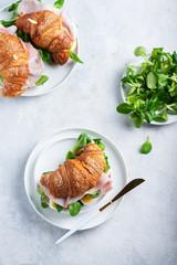Fresh croissant with green salad