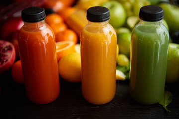 Colorful bottles filled with fresh fruit and vegetable juice or smoothie