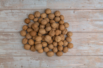 Whole walnuts on rustic old wooden table