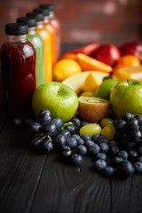 Colorful bottles filled with fresh fruit and vegetable juice or smoothie