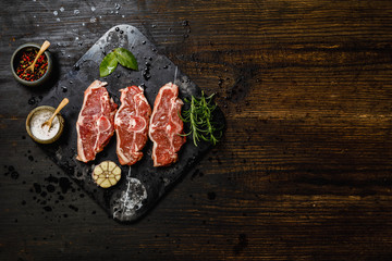 Lamb meat on stone tray on dark concrete background