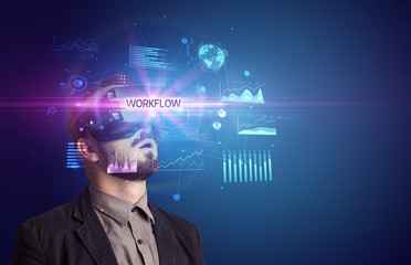 Businessman looking through Virtual Reality glasses with WORKFLOW inscription, new business concept