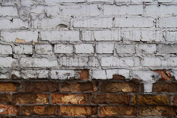 Vintage brick wall. Painted distressed wall surface. Grungy wide brickwall.