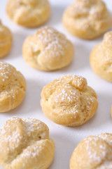 choux cream or cream puff or French profiteroles with fresh cream set on cafe table.