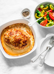Chicken meatloaf and fresh tomato yellow bell pepper vegetables salad on a light background, top view. Healthy balanced diet food
