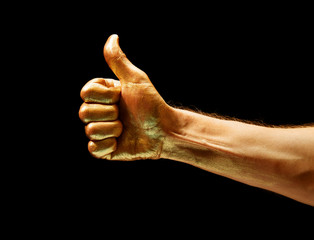 Image of gold painted Like gesture on black background