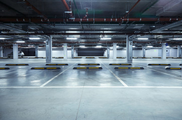 Horizontal image of empty underground parking lot - obrazy, fototapety, plakaty