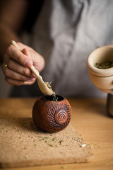Caucasian man brews calabash yerba mate