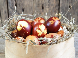Easter. Coloring eggs for Easter onion peel. The traditional method of natural coloring. Eggs in a sieve with a straw on a wooden background.