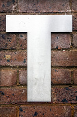 Written Wording in Distressed State Typography Found Letter T