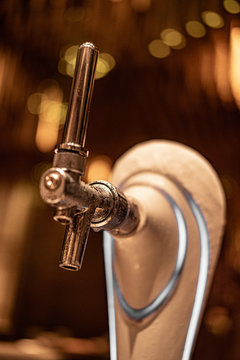 Close up chrome tap Draft Beer Dispenser, selective focus, background copy space, night time