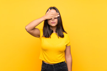 Young brunette girl over isolated background covering eyes by hands. Do not want to see something
