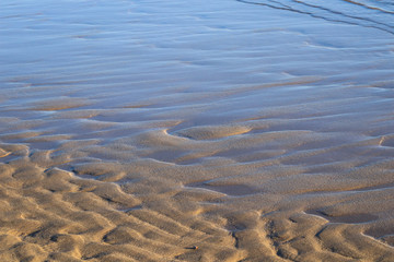 Wavy sand beach in low tide time