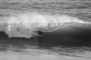 Surfer on Ocean Wave Getting Barreled at Sunset