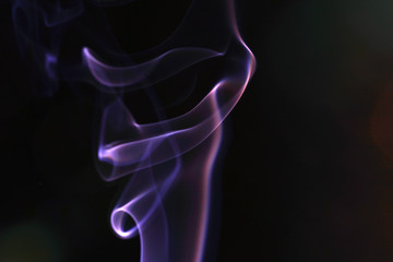 Smoke flashed with colorful foils and photographed in the studio
