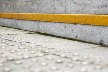 Coated steps for orienting blind people.
