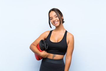 Young sport girl with boxing gloves over isolated blue background