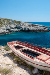 rocky greek coastline with an old destroyed boat
