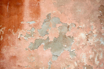 Concrete painted wall with falling cracked paint.