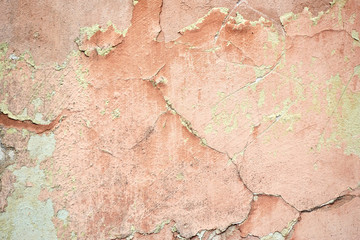 Concrete painted wall with falling cracked paint.