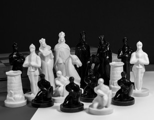 Set of chess pieces on a dark background with copy space. Board game of chess. Black and white photography