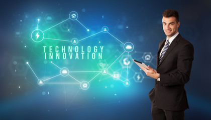 Businessman in front of cloud service icons with TECHNOLOGY INNOVATION inscription, modern technology concept