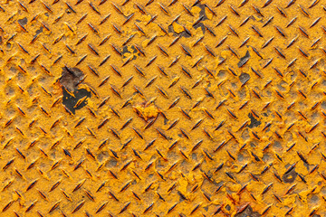 Old rusty yellow diamond steel plate detailed close up texture