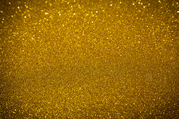 Fototapeta na wymiar Yellow gold shiny glitter abstract texture background.