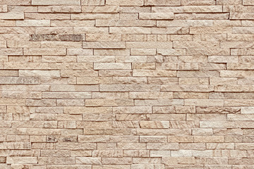 Old brick wall made of natural stone.
