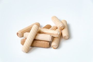 Wooden dowels on white background for connection on chipboards.