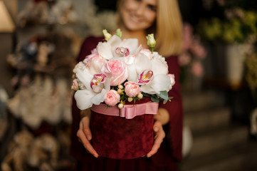 Close shot of white orchids in hat box