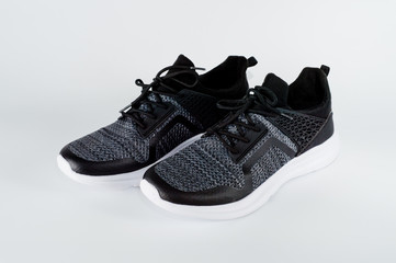 Men's sports shoes dark-colored sneakers with white soles designed for sports and everyday use