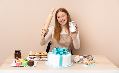 Obraz na płótnie Canvas Young redhead woman with a big cake