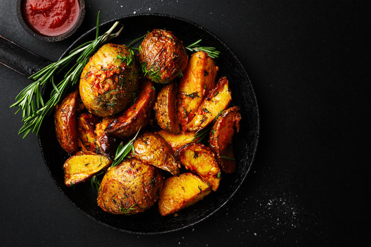 Tasty baked potato with spices and rosemary